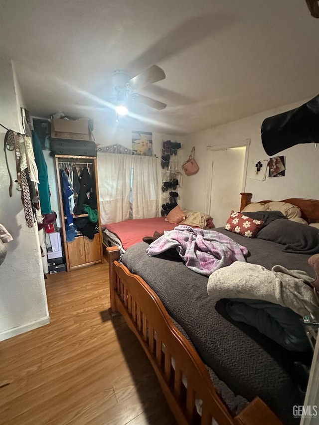 bedroom with ceiling fan and light hardwood / wood-style flooring