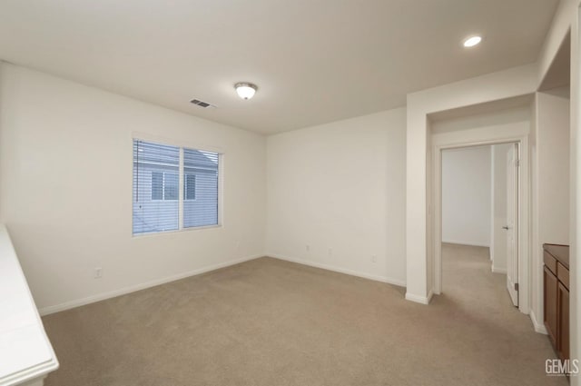 empty room with light colored carpet