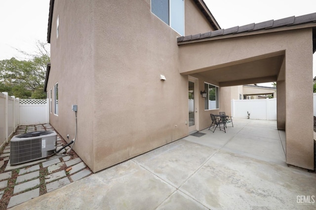 exterior space with a patio area and central air condition unit