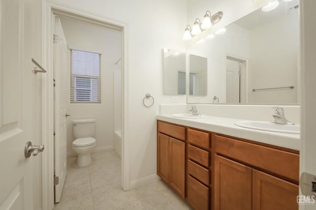 full bathroom with tile patterned flooring, vanity,  shower combination, and toilet