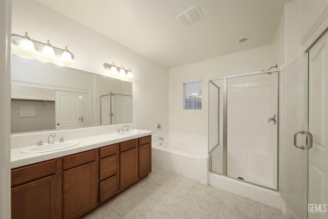 bathroom featuring vanity and independent shower and bath