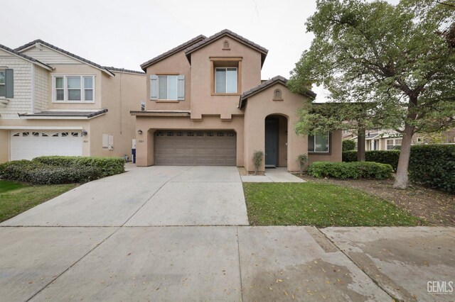 mediterranean / spanish-style home featuring a garage