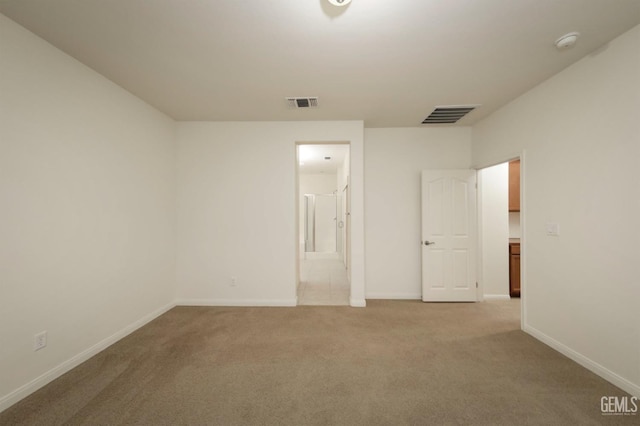 empty room featuring light colored carpet