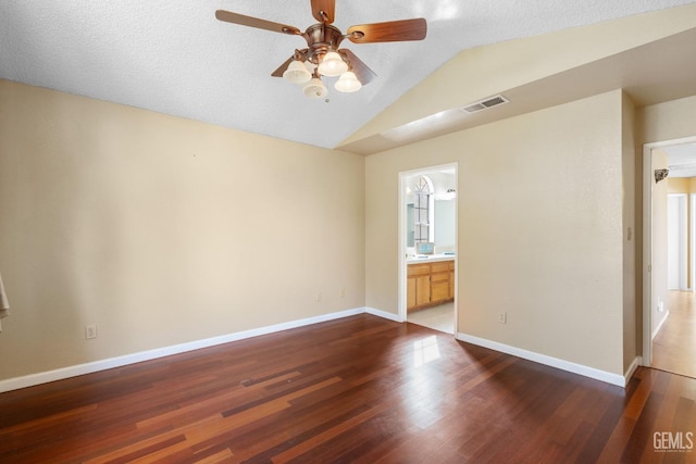 unfurnished room with dark hardwood / wood-style flooring, a textured ceiling, lofted ceiling, and ceiling fan