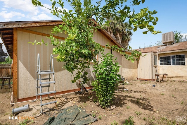 7901 Jay St, Lamont, CA 93241 - view of yard with an outdoor structure, central air condition unit, fence, and a storage shed
