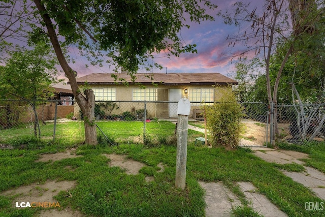 7901 Jay St, Lamont, CA 93241 - view of front of home featuring a front lawn, a gate, fence, and stucco siding