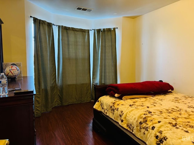 bedroom with dark hardwood / wood-style flooring