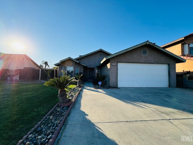 single story home featuring a garage and a front lawn