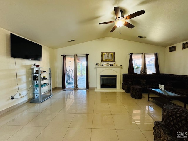 tiled living room featuring vaulted ceiling and ceiling fan