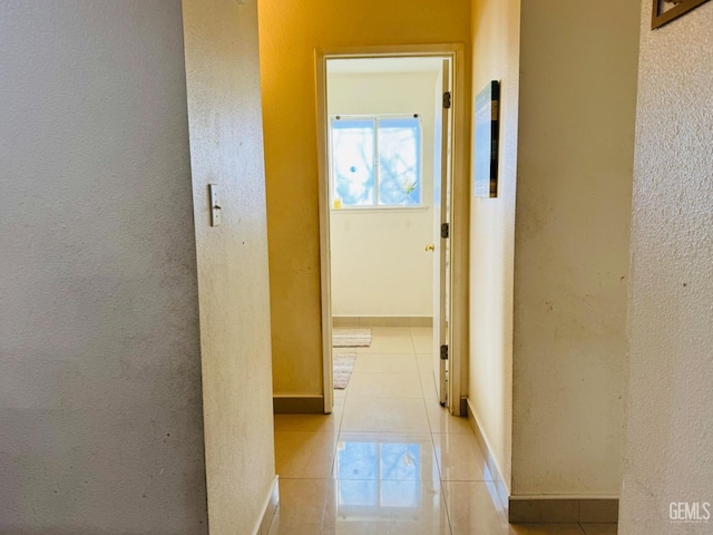 hall with light tile patterned flooring