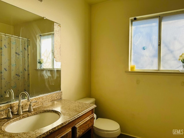 bathroom featuring vanity and toilet