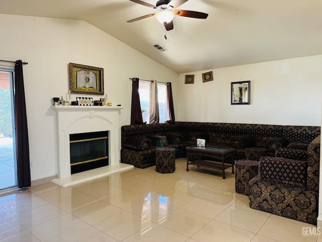 tiled living room featuring ceiling fan and vaulted ceiling