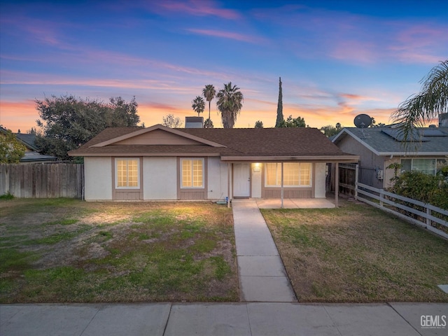 ranch-style house with a yard