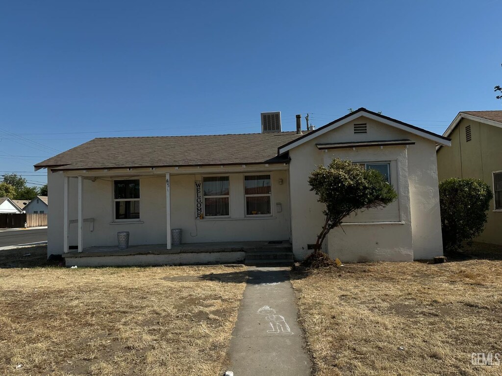131 Bernard St, Bakersfield, CA 93305 - view of front of house with cooling unit, a shingled roof, stucco siding, and covered porch