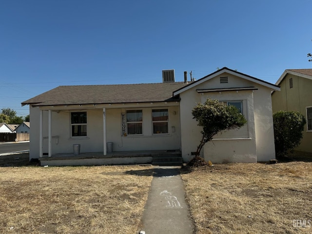 131 Bernard St, Bakersfield, CA 93305 - view of front of house with cooling unit, a shingled roof, stucco siding, and covered porch