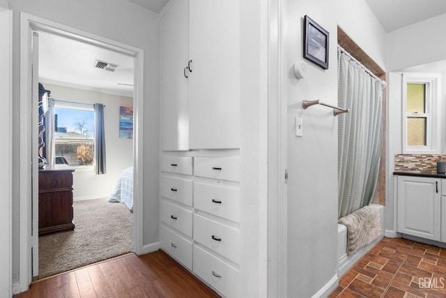 interior space featuring dark wood-type flooring and crown molding