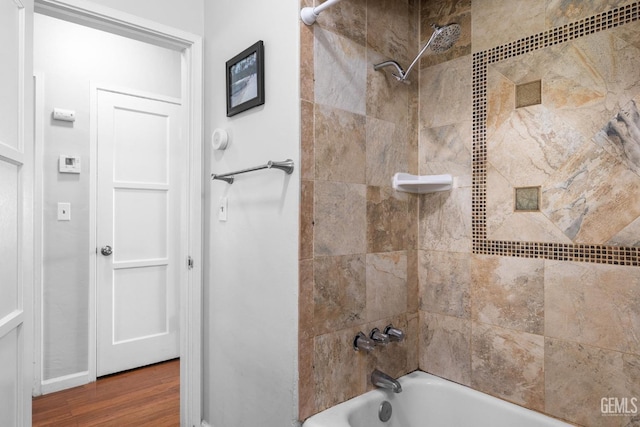 bathroom featuring tiled shower / bath combo and hardwood / wood-style floors