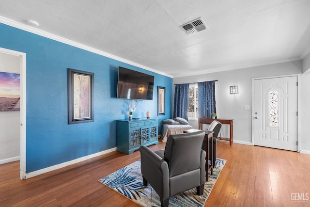 living room with crown molding and wood-type flooring