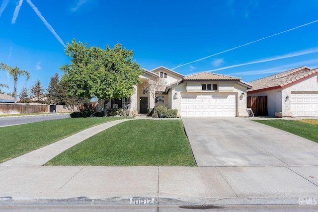 view of front of home with a garage, driveway, a tile roof, fence, and a front lawn