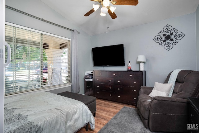 bedroom with lofted ceiling, ceiling fan, and wood finished floors