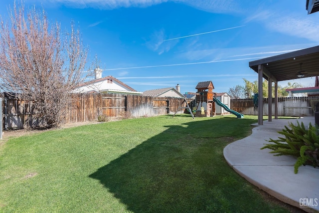 view of yard with a playground and a fenced backyard