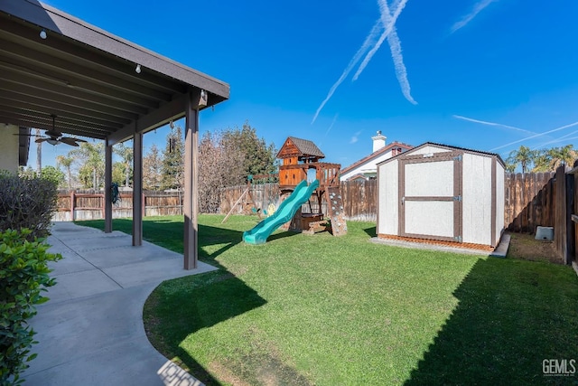 exterior space featuring a patio area, a fenced backyard, an outbuilding, and a yard