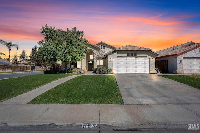 view of front of property with a garage, driveway, stone siding, a lawn, and stucco siding