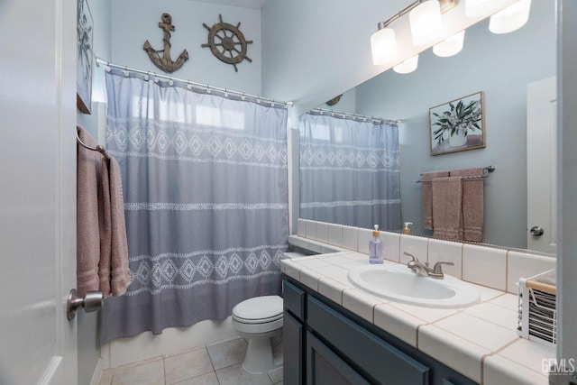 bathroom with toilet, tile patterned flooring, and vanity