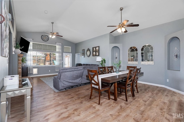 dining area with ceiling fan, baseboards, vaulted ceiling, and wood finished floors