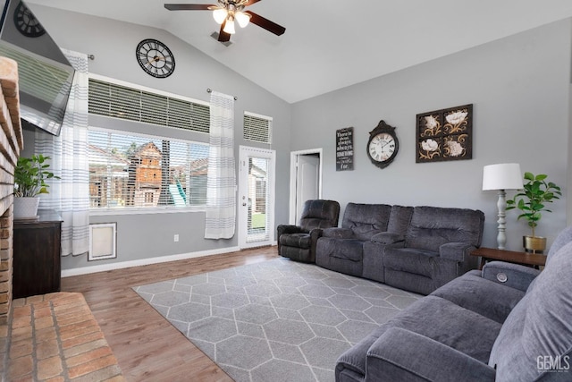 living area featuring high vaulted ceiling, wood finished floors, a ceiling fan, and baseboards