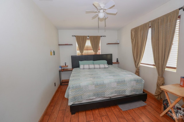 bedroom with hardwood / wood-style flooring and ceiling fan