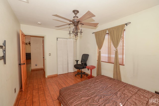 bedroom featuring hardwood / wood-style floors, a closet, and ceiling fan