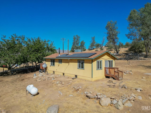 rear view of house with solar panels