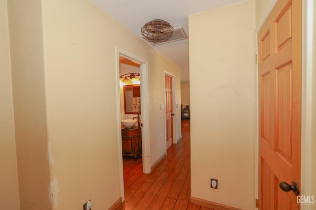 hall featuring light hardwood / wood-style floors and sink