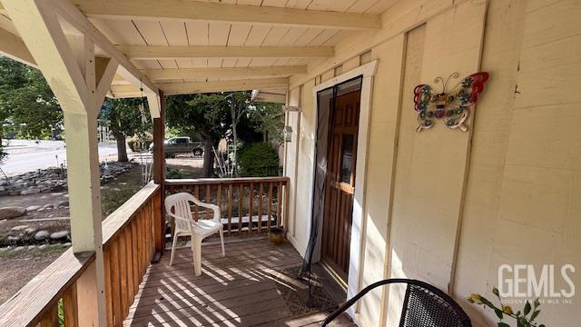 wooden terrace featuring a porch