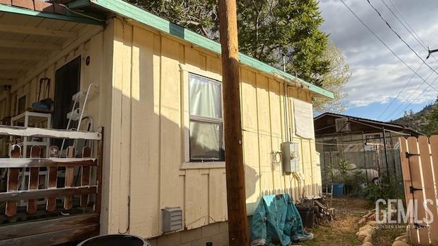view of side of home featuring fence
