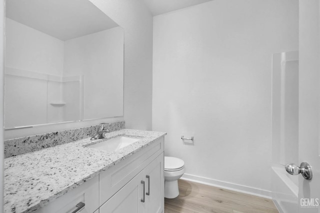 bathroom featuring hardwood / wood-style flooring, vanity, and toilet