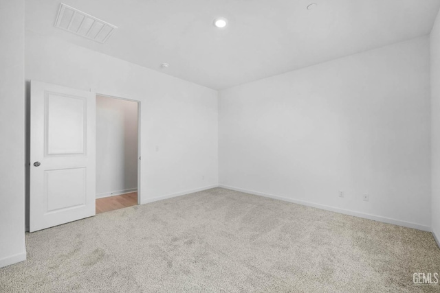 spare room featuring light colored carpet