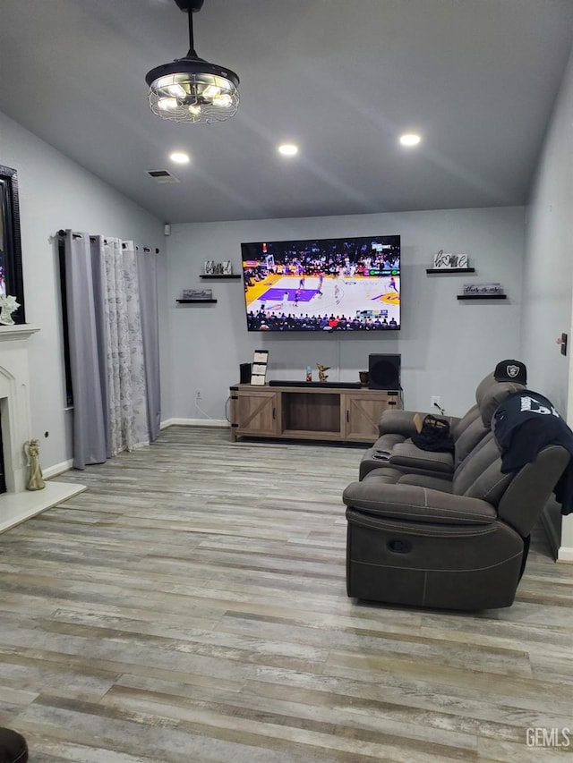 living room with lofted ceiling and light wood-type flooring