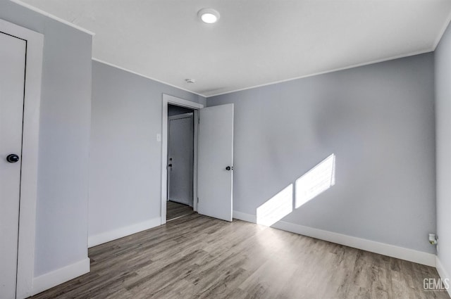 113 Lucard St, Taft, CA 93268 - unfurnished bedroom with wood finished floors, baseboards, and ornamental molding