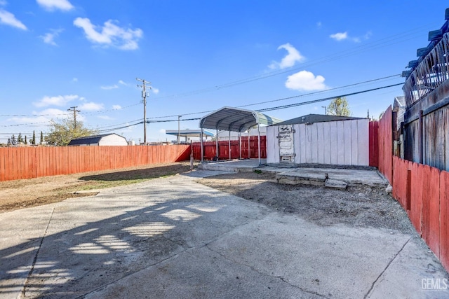 113 Lucard St, Taft, CA 93268 - view of patio featuring a carport, a fenced backyard, a storage unit, and an outdoor structure