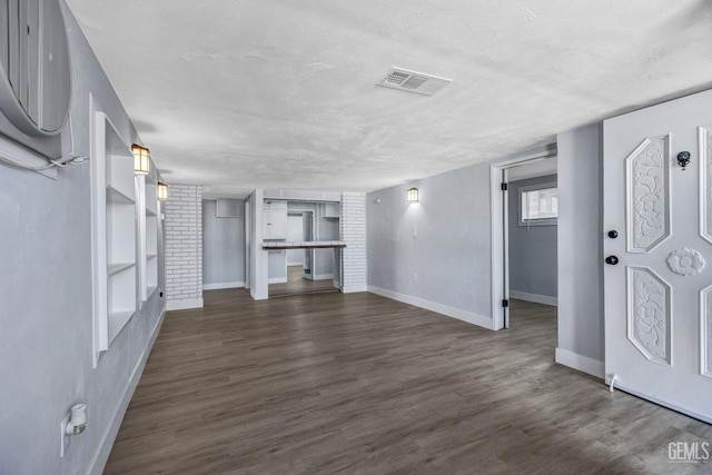 113 Lucard St, Taft, CA 93268 - unfurnished living room with baseboards, a textured ceiling, and dark wood-style flooring
