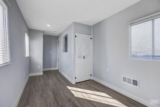 113 Lucard St, Taft, CA 93268 - unfurnished bedroom with wood finished floors, baseboards, recessed lighting, and a closet
