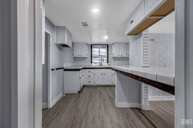113 Lucard St, Taft, CA 93268 - kitchen featuring light wood-style flooring, baseboards, white cabinets, a sink, and recessed lighting