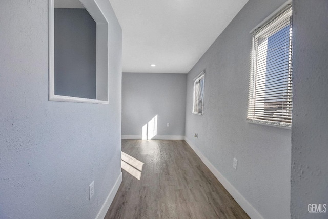 113 Lucard St, Taft, CA 93268 - hall with wood finished floors, baseboards, and a textured wall