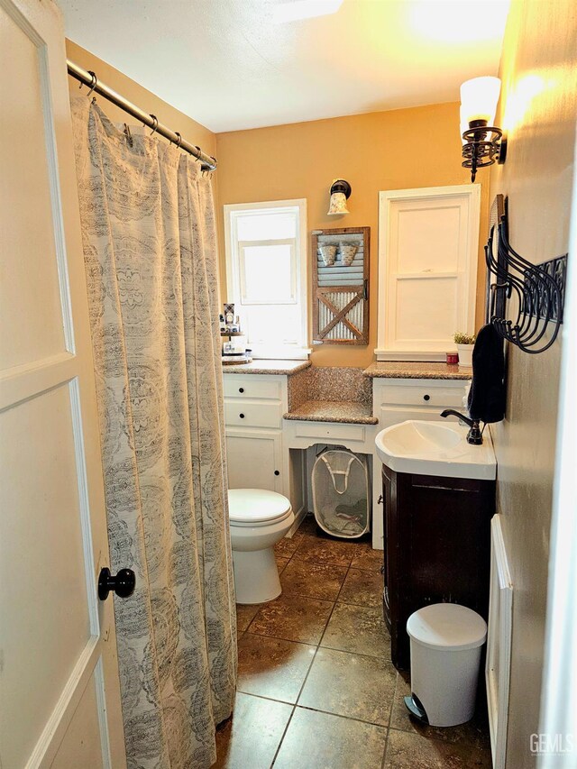 1806 Tulare St, Bakersfield, CA 93305 - full bath featuring toilet, vanity, and tile patterned floors