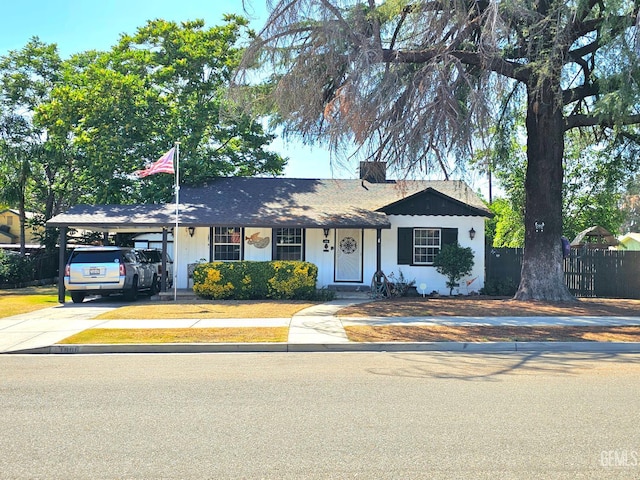 1806 Tulare St, Bakersfield, CA 93305 - view of front of house featuring driveway, a carport, and a chimney