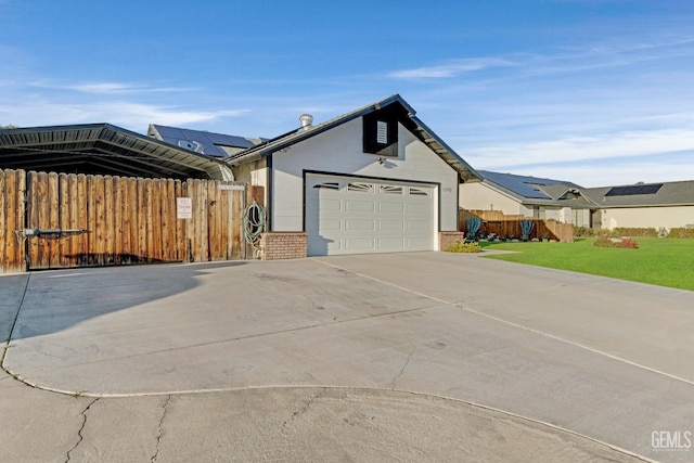 view of property exterior with an attached garage, brick siding, fence, a yard, and concrete driveway