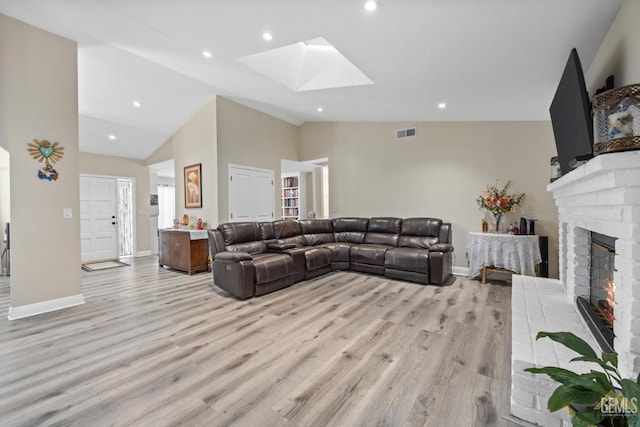 3105 Whisper Oak Way, Bakersfield, CA 93311 - living room with a skylight, light wood-type flooring, a fireplace, baseboards, and recessed lighting