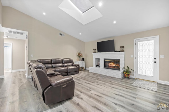 3105 Whisper Oak Way, Bakersfield, CA 93311 - living room with wood finished floors, a skylight, baseboards, a fireplace, and recessed lighting